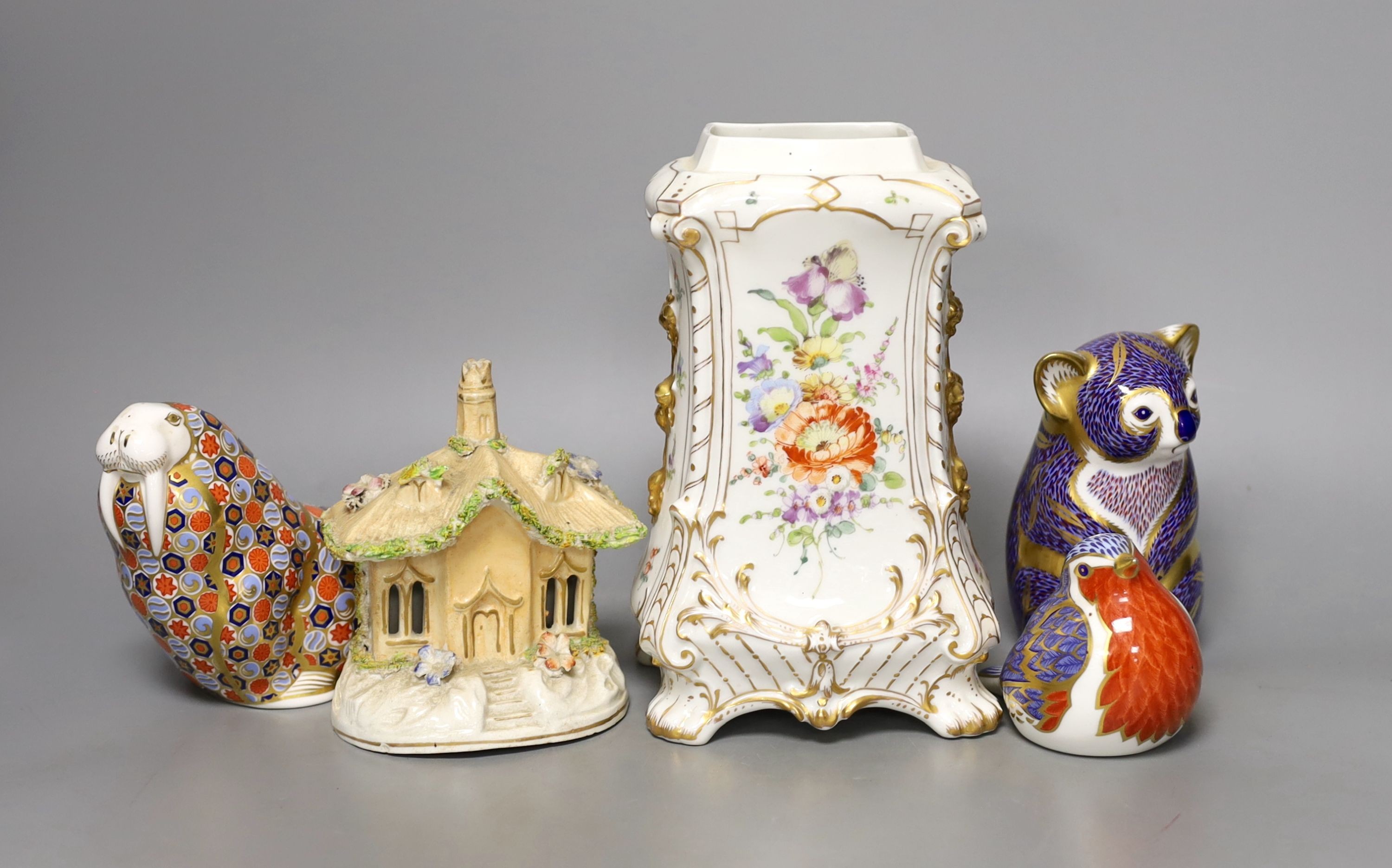 Three Crown Derby animal paperweights, a pastel burner cottage and a Continental gilt and floral decorated vase, tallest item vase 19 cms high.